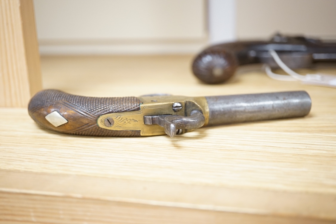 A boxlock percussion pocket pistol with turn off barrel, Birmingham proofs, engraved brass frame, and chequered rounded walnut grip